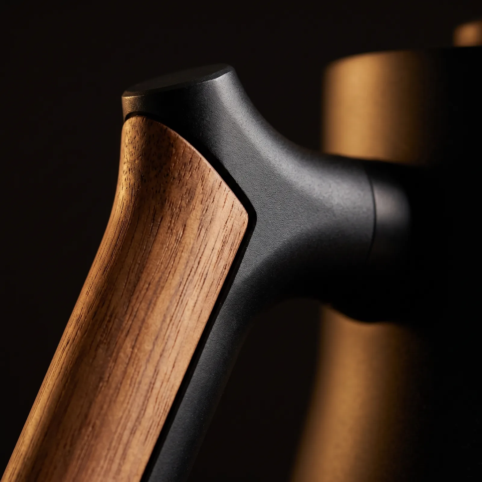 The counterbalanced handle where wood meets matte black — close up